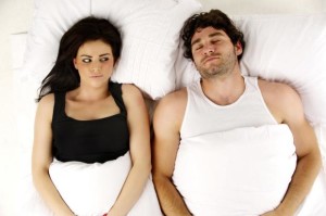 man-and-woman-laid-in-a-white-bed